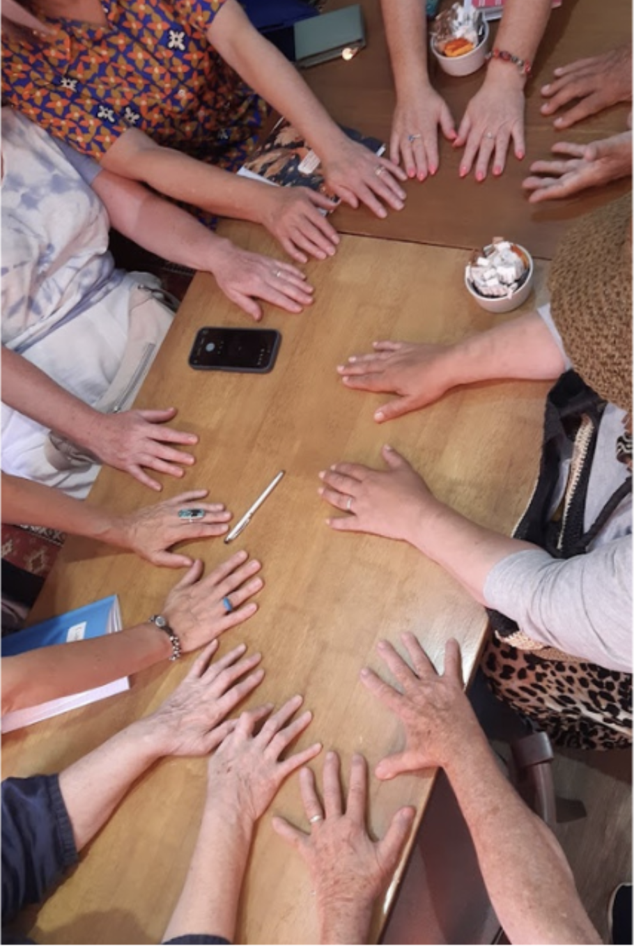 Writers' hands spread out around a café table